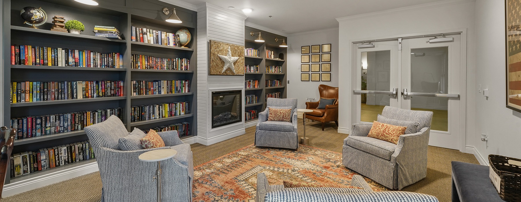 a room with bookshelves and chairs