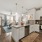 pendant lights over kitchen counter open to living room