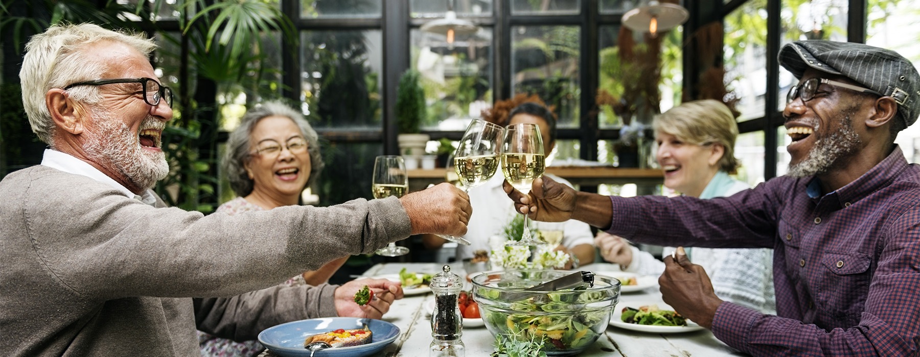 a group of people toasting wine glasses